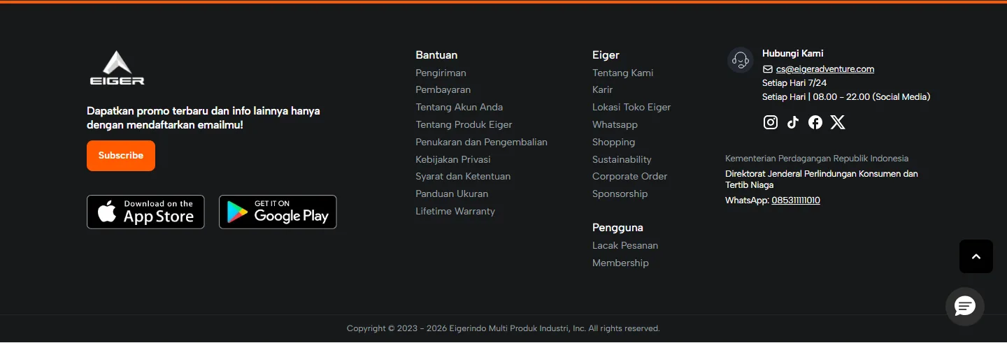 Tangkapan layar footer gelap situs Eiger: logo Eiger, ajakan mendaftar email promo dengan tombol Subscribe, tautan App Store dan Google Play, kolom Bantuan berisi Pengiriman, Pembayaran, Penukaran dan Pengembalian, Kebijakan Privasi, Panduan Ukuran, kolom Eiger, kolom Pengguna berisi Lacak Pesanan dan Membership, kolom Hubungi Kami dengan email dan jam layanan, kontak pengaduan konsumen Kementerian Perdagangan, dan baris hak cipta